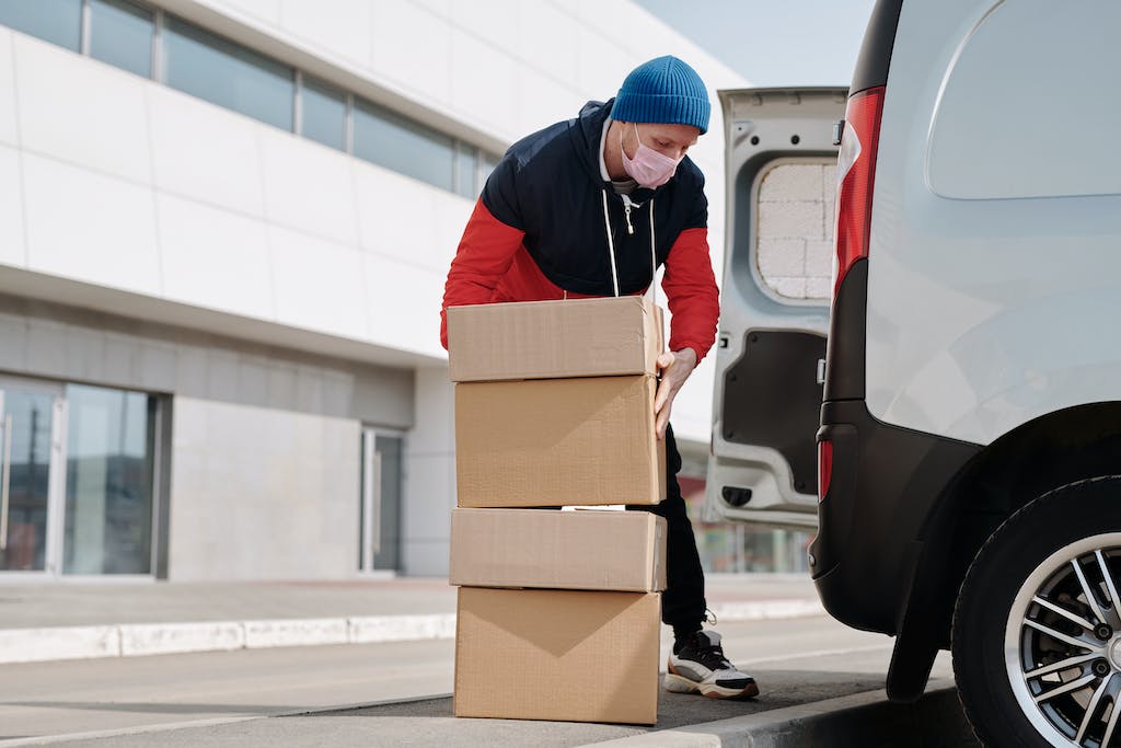 Delivery Man Wearing a Face Mask Carrying Boxes